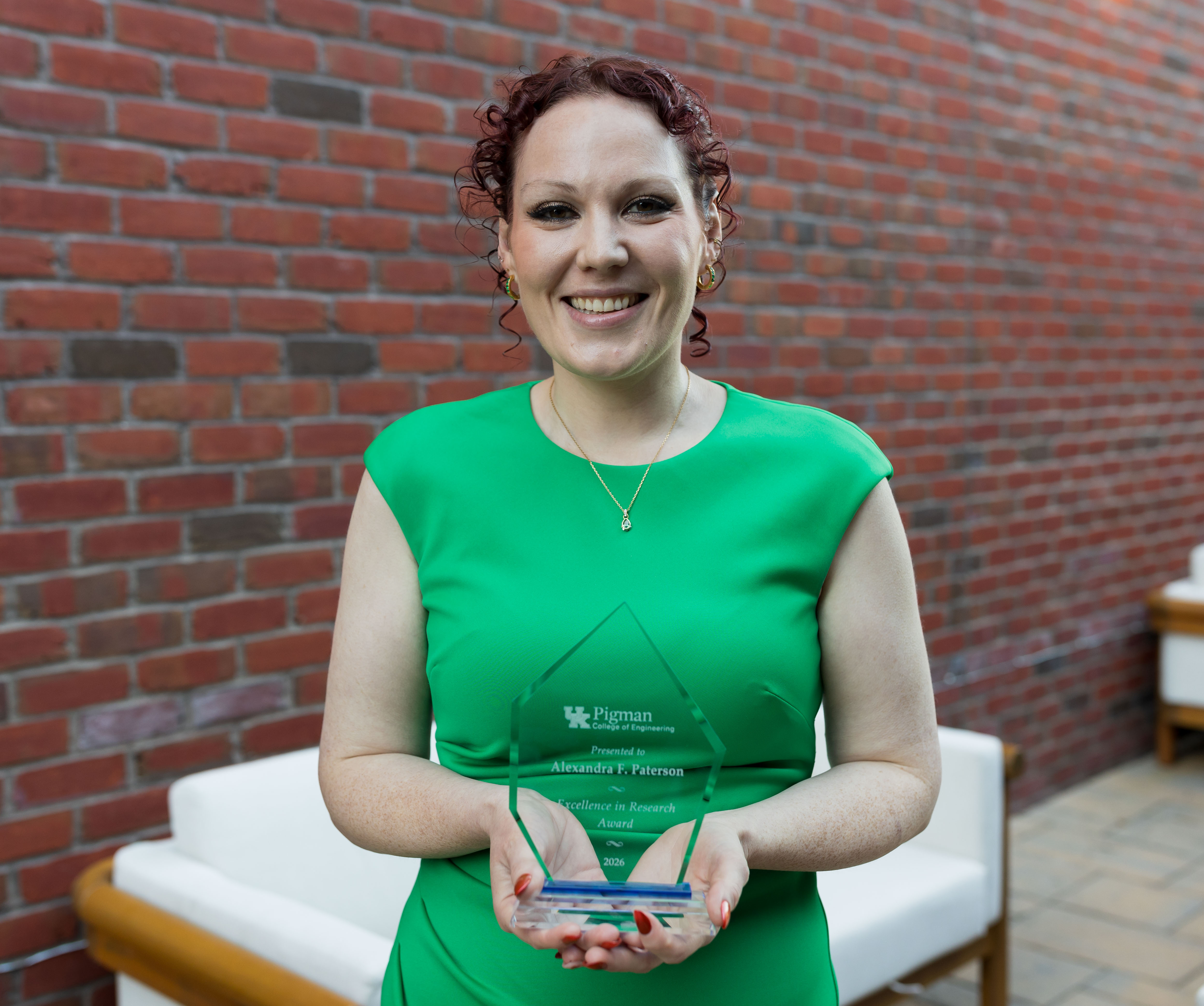 Alexandra Paterson holding 2026 Faculty Award outside