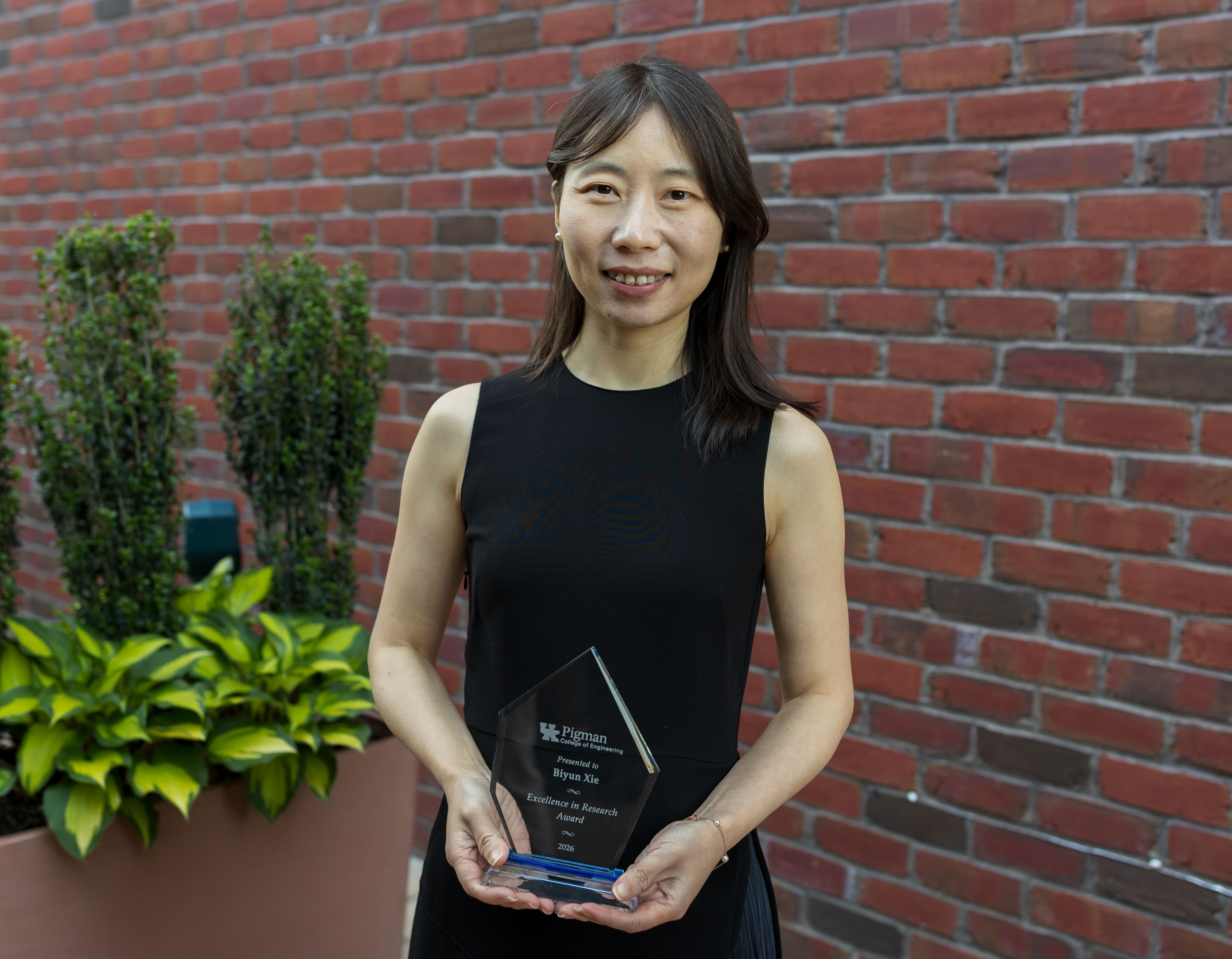 Biyun Xie holding 2026 Faculty Award outside 
