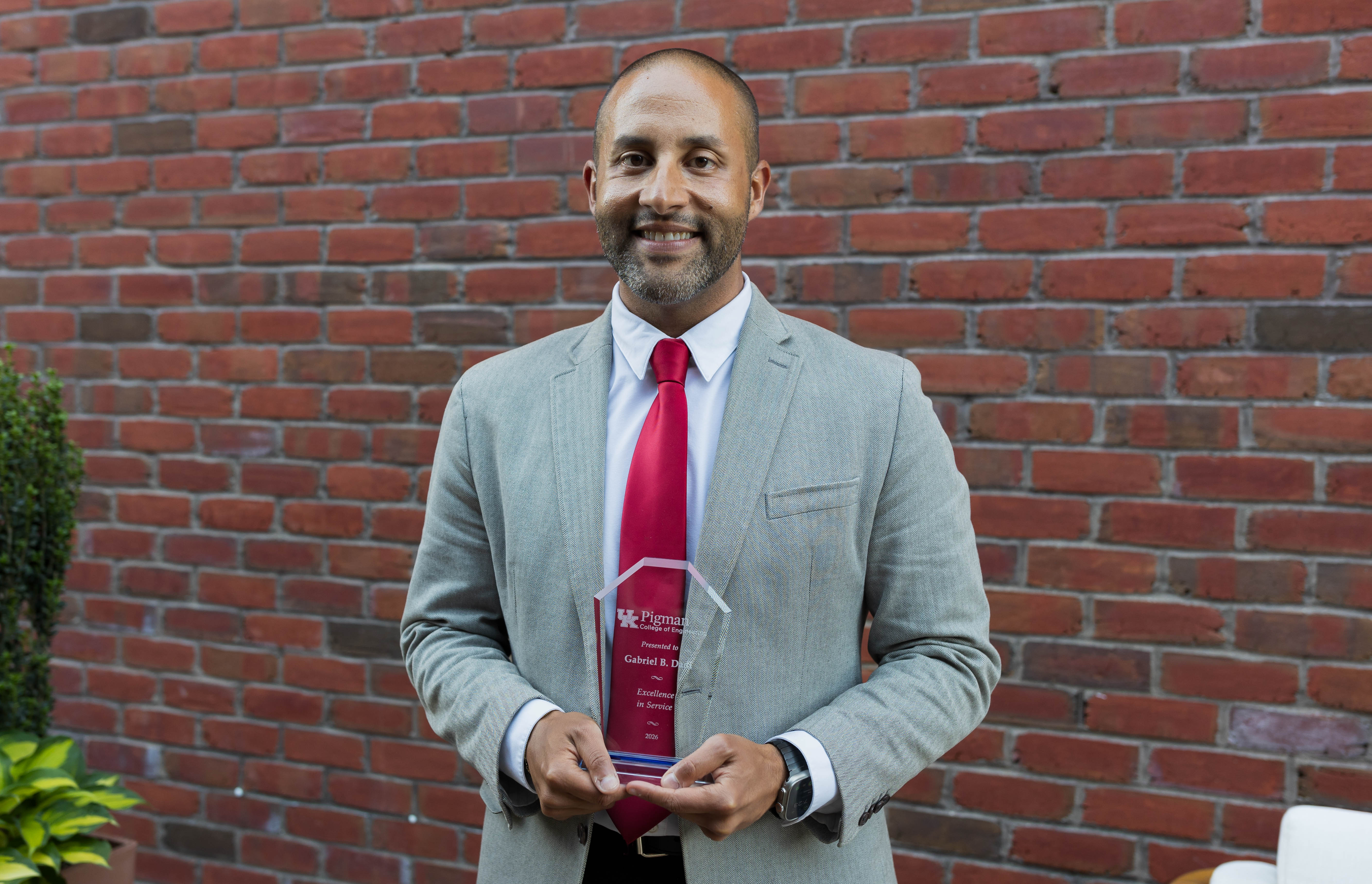 Gabriel Dadi holding 2026 Faculty Award outside 